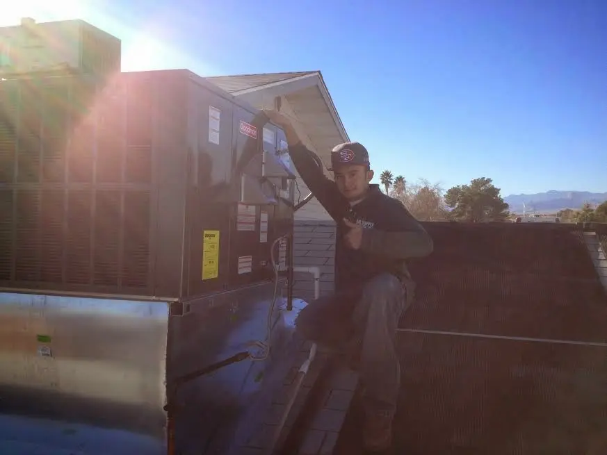 HVAC technician performing HVAC Inspection on a rooftop unit in Oroville